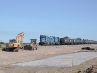 The Nanticoke Road Switcher sits idle in the SOR's Garnet yard awaiting its crew to come on duty.  In the foreground of this image are many earth moving machines that have been doing a lot of work alongside the yard.  They will be installing new yard tracks where to work has been done in the photo.  It has also been said that the GP20D's will be returning to CEFX as soon as new power arrives from G&W
