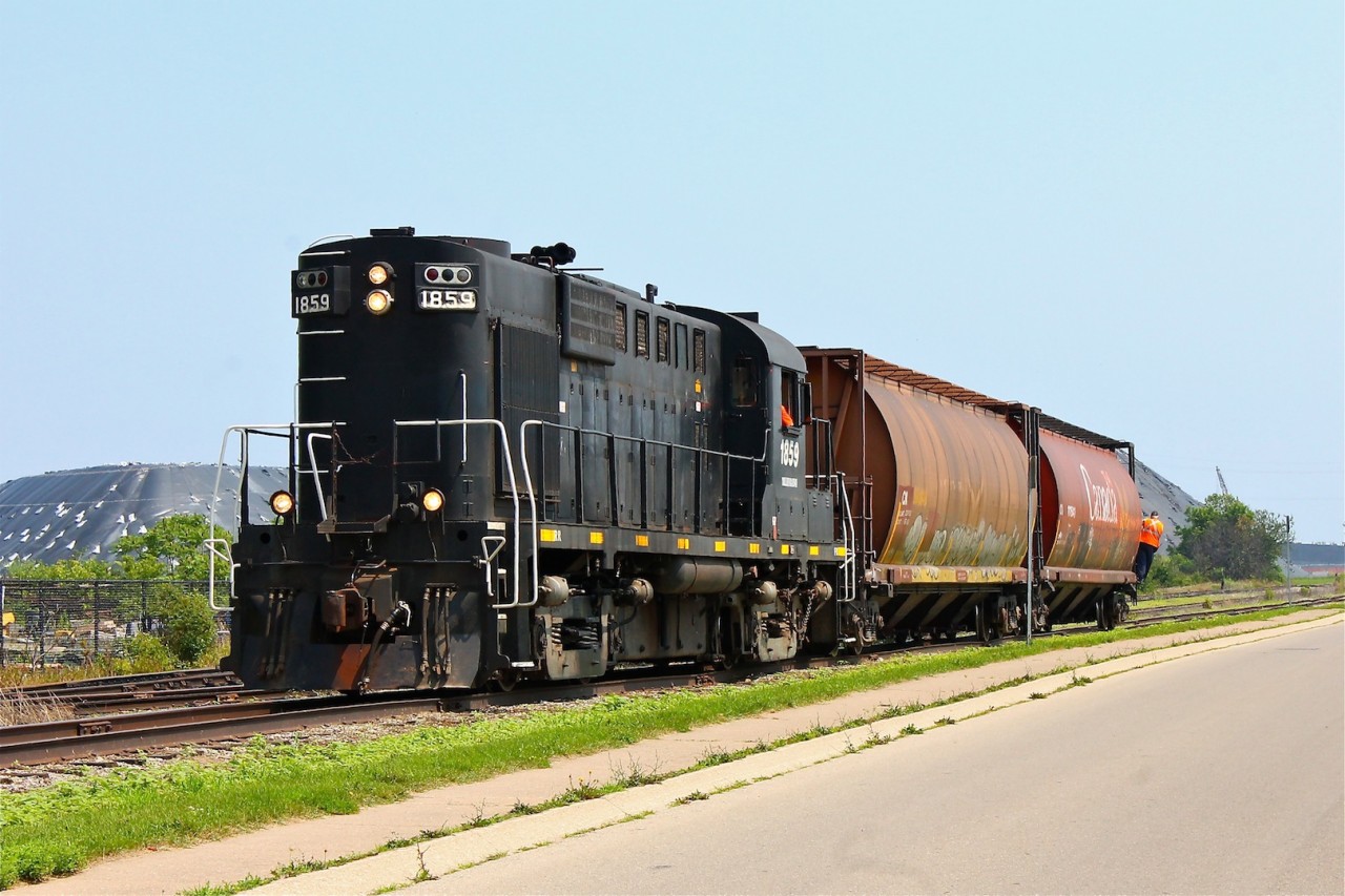 At this point I had my fingers crossed hoping that the kind engineer would open up the throttle and really lay on some of that thick black smoke that ALCO's are so famous for, but no luck. Either way I still feel fortunate to have been able to shoot such an attractive unit as an RS18u on such a beautiful day. Here 1859 is pushing two hoppers down to Southpier Terminals, this would be the end of the chase for us.