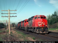 CN 9520 leads this westbound around the curve @ Denfield Road just west of London, Ontario.  Shot from between the CN and CP mains, you'd need a chainsaw and about a week to clear brush to get this shot today.