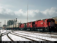 "CAT Power" leads train #904, CP's flagship train out of Windsor, past the west end of Chatham Yard on February 8, 1992.  Caterpiller rebuild 4711, leads 2 more "BIG M's" through the snow today.  Now, in 2013, it would be a non-descript pair of burnt up GE's, which is why I have a hard time getting out of bed to shoot on the CP anymore....