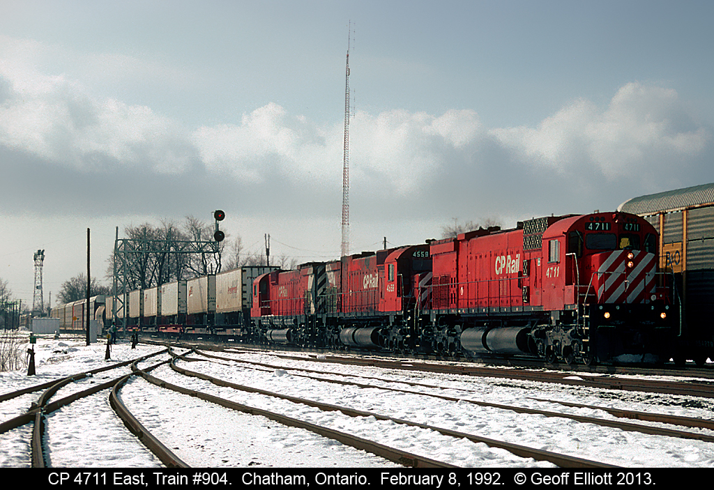 "CAT Power" leads train #904, CP's flagship train out of Windsor, past the west end of Chatham Yard on February 8, 1992.  Caterpiller rebuild 4711, leads 2 more "BIG M's" through the snow today.  Now, in 2013, it would be a non-descript pair of burnt up GE's, which is why I have a hard time getting out of bed to shoot on the CP anymore....