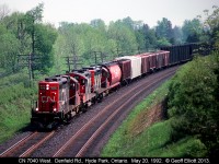 CN 7070 leads a trio of rebuilt GP9's around the curve at Denfield Road back in 1992.  Doesn't seem like much of a grade here but westbound trains had to pull up out of the Thames Valley and believe me, those GP9's are working hard as they lead this London to Sarnia transfer!!