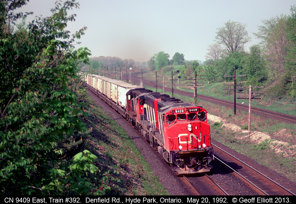 No stacks, no racks, just wells full of trailers as CN 9409 heads up eastbound "Laser" train #392 at Denfield Road back in 1992.