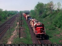 A pair of white SOO's, led by #778, lead Train #504 through 'Lobo' and under the Denfield Road overpass on May 20, 1992.