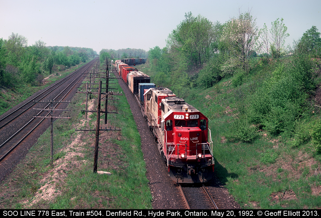 A pair of white SOO's, led by #778, lead Train #504 through 'Lobo' and under the Denfield Road overpass on May 20, 1992.