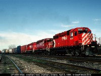 CP 5669, with 3 shades of red SD40-2's, leads a westbound through the east end of Chatham Yard after just having crossed the Thames River (in the background) on it's way to Windsor.