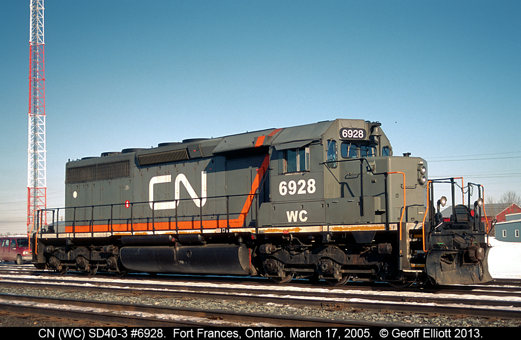 WC (CN) SD40-3 #6928 sits at the west end of Fort Frances yard waiting to be lifted by a westbound train that is arriving after coming north to International Falls, MN on the DW&P.