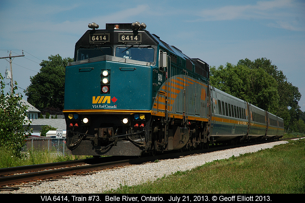 The 40kmph sign in the background certainly does not apply here as VIA 6414 makes track speed as it flies through Belle River, Ontario on July 21, 2013.