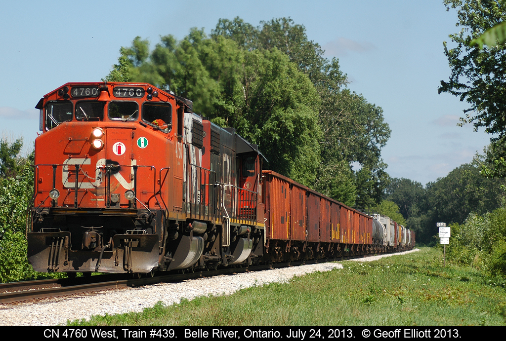 CN train #439 picks up speed as it heads west through Belle River. A cut of 10 ballast cars head up the train, but CN has let most of it's infrastructure in Windsor be torn up, so who knows what the ballast is for. Maybe they are 'rail shiners' like Conrail used to use on the CASO back in the day.... :-)