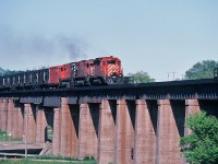 The Multi-Mark Rules !
<br>
<br>
Long Live the Multi-Mark !
<br>
<br>
To commemorate the 2013 CARM Convention ( August 9 to 11 ) in Port Hope please enjoy this June 27, 1982 image of a westbound CP Rail on the Ganaraska Viaduct. 
<br>
<br>
Multi-Mark adorned: CP Rail SD 40 #5542 is assisted by two MLW M 636 #471x and #47xx with a long string of open double deck autoracks destined for the GM plant in Oshawa. ( 5542 sold to National Railway Equipment in 2004).
<br>
<br>
June 27, 1982 Kodachrome by S. Danko.
<br>
<br>
More Port Hope:
<br>
<br>
<a href="http://www.railpictures.ca/?attachment_id=2116">  CN time at Port Hope  </a> 
<br>
<br>
<a href="http://www.railpictures.ca/?attachment_id=9629">  VIA at Port Hope  </a> 
