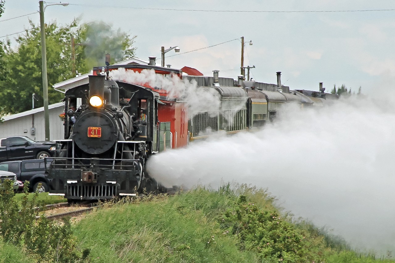 Another view of 1920 built Baldwin 2-8-0 #41 departing Stettler with the Alberta Prairies Railway Excursions passenger train for the 90 minute journey to Big Valley. Putting on a great show of blowing off steam as it coaxes the train into motion.