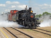 1920 built Baldwin 2-8-0 /41 blows off a good head of steam as it prepares to bring the train into the station.