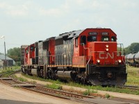 CN 6025, CN 5696 and IC 6137 power an eastbound (392?) which has just arrived at Brantford to set out an IC boxcar.