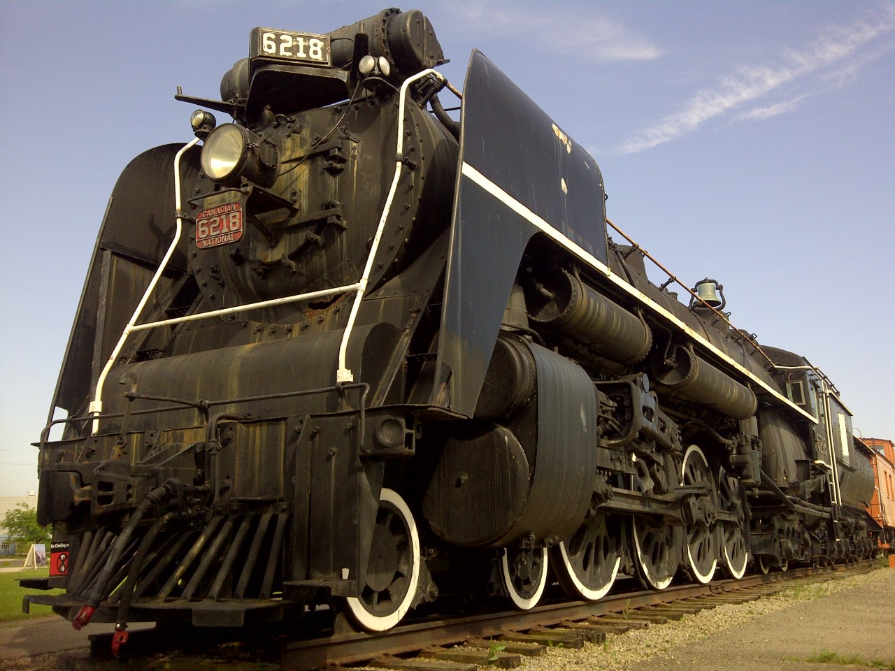 CN 4-8-4 Mountain Type 6218 has deteriorated tremendously over the years it has sat on display in Ft. Erie, ON.  The boiler cover has rotted away in several locations exposing the fiberglass insulation underneath and the once shiny black paint has dulled to a powdery grey and rust smeared coat. Based on the condition of this once beautiful locomotive, I highly doubt it will ever roll from its current resting place, and will most likely collapse on itself in the years to come. What a shame!