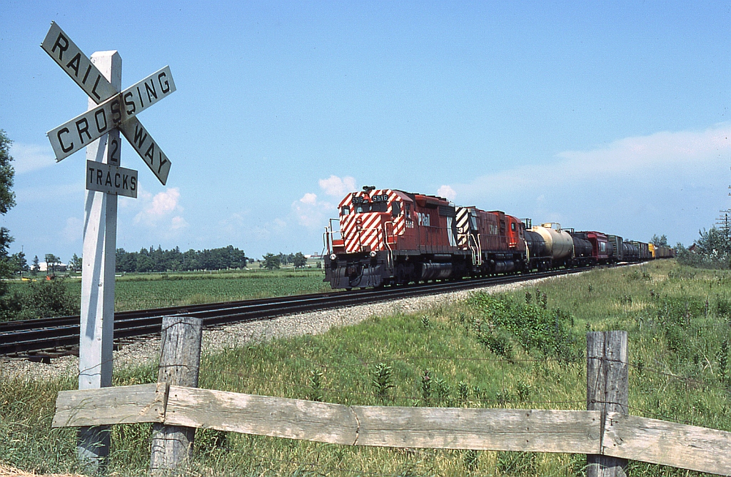 A westbound freight, with CP 5516 and 4503 as power, takes the siding at Lobo for a meet. The crossing in the foreground is probably near the west end of the siding, at either Vanneck Road or Lobo Township Road (can any locals confirm?).