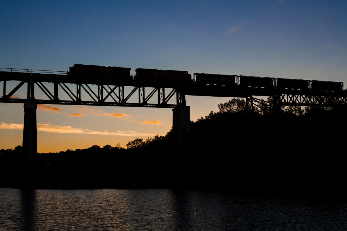 Minutes before sunrise, a northbound Canadian Pacific freight train soars across the Seguin River trestle in the small town of Parry Sound, Ontario creating a nice silhouette. With a few blasts of the horn and a friendly wave from the crew, this was the start to a good day. Visiting the familys' annual mid-July cottage rental in the town of Burks Falls, nearly 70KM SW of Parry Sound, I decided to hit the road at 0445 to try my luck trackside. After making a quick stop at Timmies - with a Large coffee in hand and a perfectly timed northbound, things couldn't have been more satisfying. Thanks goes to RP contributor W.D Shaw for information on railfanning Parry Sound and suggesting this location for an early morning picture!