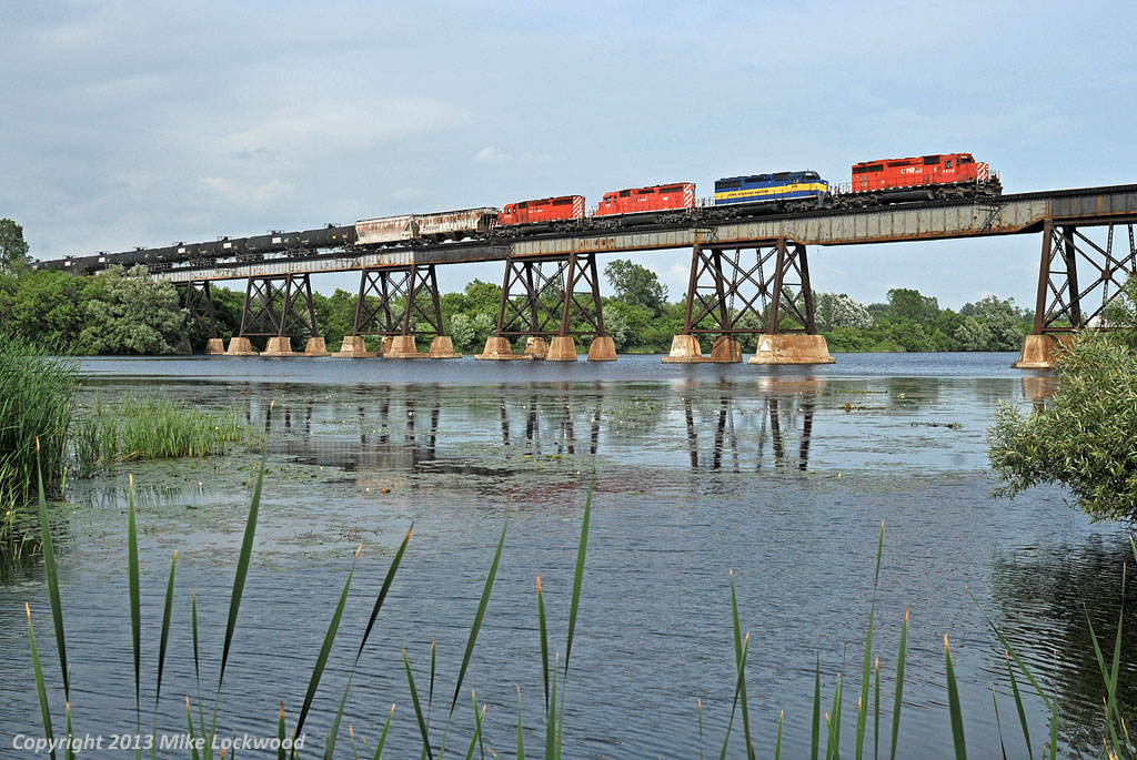 A quartet of SD40's roll empty ethanol tanks west high above the Trent River at Trenton, Ontario. In another life, the third unit was CP 5411, originally QNS&L 215, an SD40 that has found it's way back to familiar rails. Power is, in order of appearance - CP 5926, ICE 6416, DME 6087, CP 5972. 1738hrs.