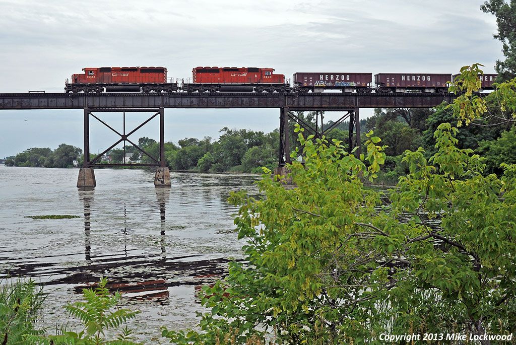 The lankly look of the SD40-2 is evident as CP 6024 and 5945 head out onto the trestle over the Trent River. 1805hrs.