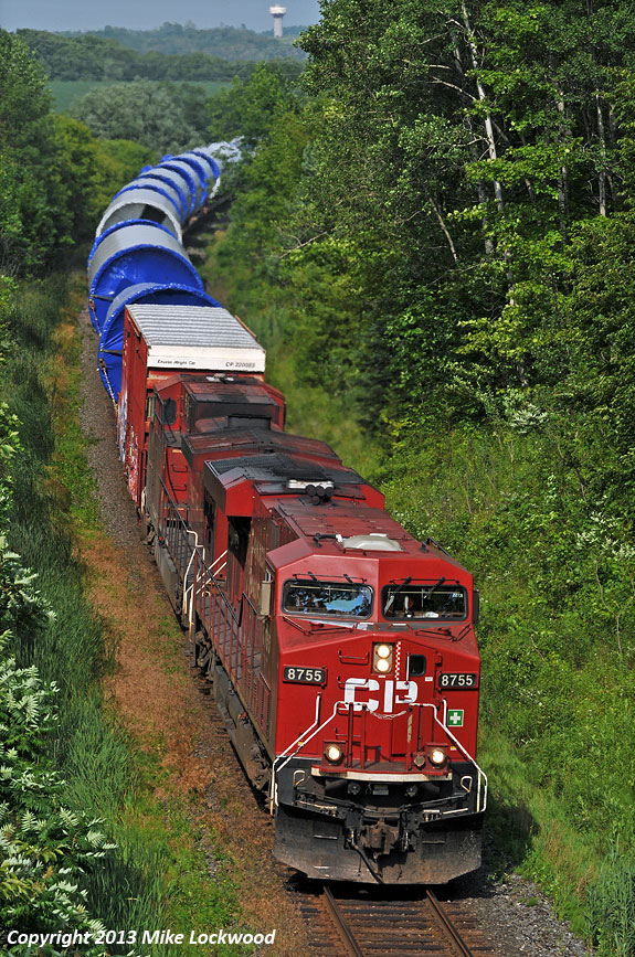 I'd love to green power move this many windmill parts overland. A pair of nasty oil burners haul a westbound special move of snake oil at Wesleyville behind CP 8755 and 9676. At least the crew got a good laugh seeing me standing on the roof of my Element for a little more elevation on the bridge. 1643hrs.