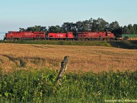 CP 9350, 1404, and 8854 roll 240's train east at Lovekin between a field of grain and Lake Ontario. Stacks capped, 1404 isn't do any of the work as it heads to St Luc for storage. One wonders if in 1975 when she was built as MILW 468, anyone could have imagined shed end up as a CP unit being hauled dead to Montreal between a pair of Gevo's. Probably not. 1959hrs.