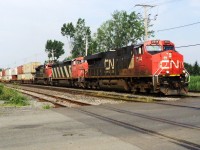 CN-2344 a EC44DC leading follow by CN-2404 C40-8M and CN 8952 SD 70m2 pulling a covoy of containers going to Halifax N.S.on rte 120 the convoy had to stop in Soutwark yard after clearing St-Georges crossing in Lemoyne to fixe a brake problem after  