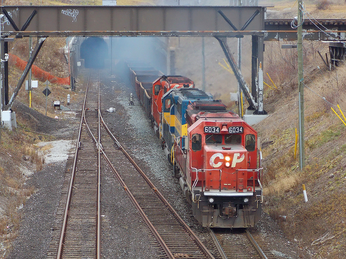 SD40-2 #6034 bursts out of the Detroit River tunnel in a cloud of exhaust with a CP freight at Windsor, ON. For more pics & videos from my collection see  http://northamericabyrail.info