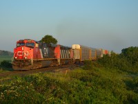 With the sun just coming up, CN 148 heads eastbound out of Sarnia after just clearing CN Mandaumin.