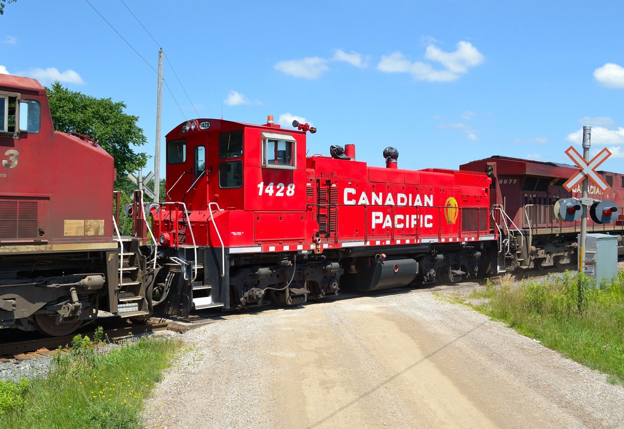 CP 1428, an MP15, trails on CP 240 on its trek to Montreal