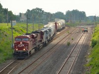 After lifting a pair of CITX and CEFX leasers from Walkerville Yard, CP 243 heads down the grade towards the tunnel to Detroit while a foreman looks on.