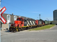 CN 4112 & 7058 paired up are seen pushing a cut of hopper cars back down the CN Point Edward Spur along the Sarnia waterfront.