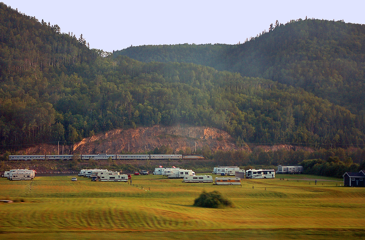 The race is on. From onboard the 'Ocean Limited' bound for Halifax, across the Restigouche River valley we see the section bound for Gaspe, otherwise known as the 'Chaleur', that had uncoupled from our train at Matapedia and is now operating as a separate train for the remainder of its trip to the Gaspe Peninsula. For more pics & video from my collection see  http://northamericabyrail.info