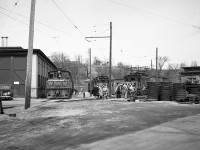 Grand River Railway's Preston Shops is shown here full of freight and passenger equipment. GRR motor 230 is shown beside the shop building on the left, its end banner checker boards were installed in fall of 1949 and removed in 1953 when the motor was overhauled and rebuilt, helping to confirm the photo was taken in 1950. Beside it on the right is LE&N motor 333, and beside that is one of the three “big” motors, LE&N motor 337. Motor 337 was built by Preston Car and Coach in 1921 with two sisters, GRR 226, 228 as shells. The finishing electrics, all from Westinghouse, were installed by the Preston GRR shops. In the mid 1950s these motors (as were 9 of the 10 motors used on the railway) were rebuilt, made much heavier, and some were given larger traction motors. <br><br> On the right are piles of wheels. Preston had their own truing machine in the shop and in 1949-1950 replaced all of the wheels and tires on all of the passenger cars with larger diameter wheels. These wheels piles are part of that exercise. <br><br> In 1961 the line was dieselized by parent CPR using SW1200RS units, which were based out of Preston Shops. Today all that remains in this scene is the power house at right, and the mainline track (behind the photographer, and curving in the distance in the background far behind the engine building in photo above). <br><br> Photo taken by Cecil Hommerding, from the collection (Copyright) of Doug Leffler. Substantial caption information provided by George Roth et al with much thanks. <br><br> <i><u>Other photos at Preston:</u></i><br> GRR freight motor 230 at Preston Shops: <a href=http://www.railpictures.ca/?attachment_id=10297><b>http://www.railpictures.ca/?attachment_id=10297</b></a><br> LE&N freight motor 333 at Preston Shops: <a href=http://www.railpictures.ca/?attachment_id=10747><b>http://www.railpictures.ca/?attachment_id=10747</b></a><br> GRR passenger motor 848 at Preston: <a href=http://www.railpictures.ca/?attachment_id=10298><b>http://www.railpictures.ca/?attachment_id=10298</b></a> <br><br> For more details on Cecil, see <a href=http://www.railpictures.ca/?attachment_id=10297><b>here</b></a>.
