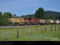 Eastbound empty US grain with UP5533-CP8775 and trailing DPU CEFX1006 seen sifting through Bull River in the Kootenay River Valley along the Cranbrook Sub.