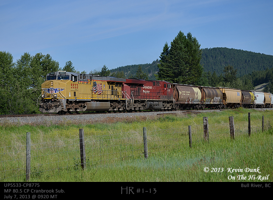 Eastbound empty US grain with UP5533-CP8775 and trailing DPU CEFX1006 seen sifting through Bull River in the Kootenay River Valley along the Cranbrook Sub.