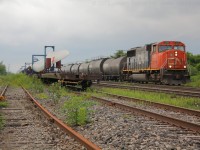 CN L394 rolls through the yard at Paris with 22 tank cars of interchange traffic from the SOR and are heading to  CN Mac Yard in Toronto.  Just a few minutes earlier L394 dropped the windmill blades on the left of the image off for the SOR to lift either tonight or tomorrow