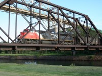 CN SD70M-2 brings in the daily northbound freight train from the United States across the ancient swing bridge over the historic Canadian ship lock canal at Sault Ste. Marie, Ontario. Built in the 1890s to allow ship traffic on the lakes to pass between Lake Superior and Lake Huron, this lock now only handles smaller recreational traffic, with today's modern massive lake freighters using the newer, larger locks on the American side of the river at Sault Ste. Marie, Michigan.