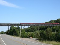 CN F40PH 105 leads an 8-car 633, the northbound Algoma Central Railway Agawa Canyon Tour Train crosses the Bellevue Trestle enroute to Agawa Canyon Park. CN 104 is bringing up the rear of the train in a push-pull configuration so that no runaround move needs to be made at Canyon.