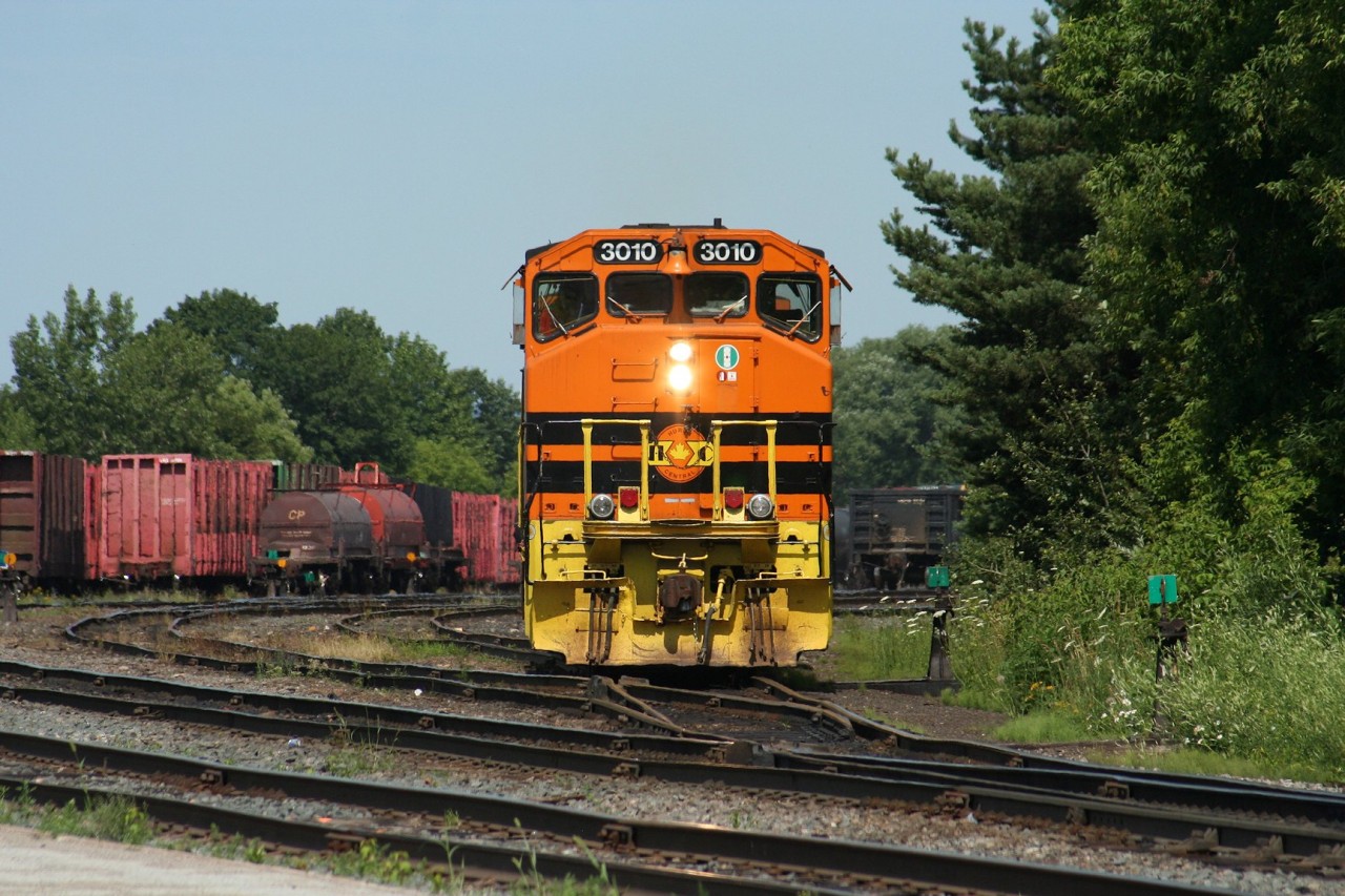 An almost perfectly matched set of wide-nose Huron Central GP40-2s (the third unit is a GP40-2L with the taller frame) switches cars at the Huron Central yard in Sault Ste. Marie.