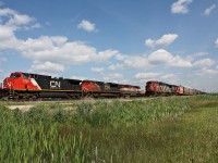 One of the twins rolls through Watrous as everything including 117 502 and 403 with a SD60F leading gets parked and out of its way.