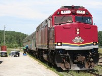 CN F40PH 106 in the handsome new Agawa Canyon Tour Train livery heads CN train 632, the regular thrice-weekly passenger train from Hearst to Sault Ste. Marie. Running over an hour late into Hawk Junction, the train stops briefly to load a trio of canoers and their gear before continuing south.