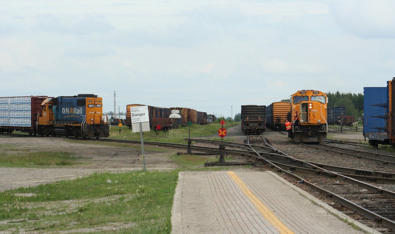 While GP38-2 1801 switches local cars at left, train 213 from Englehart has just arrived with SD75i 2102. After wying the engine, the 2102 will leave again for Englehart on train 414.