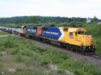 Ontario Northland GP38-2s 1809 and 1804 power the northbound Cochrane to Moosonee Polar Bear Express past Milepost 5.0 of the Island Falls subdivision. This train is notable for being the last operating mixed train (handling freight and passengers) in Ontario. <br><br> The full consist of this day's Polar Bear Express was as follows:<br> ONT 1809 (GP38-2)<br> ONT 1804 (GP38-2)<br> ONT 100504 (Vehicle flatcar)<br> ONT 100506 (Vehicle flatcar)<br> ONT 100502 (Vehicle flatcar)<br> ONT 7776 (Boxcar)<br> ONT 855 (Coach)<br> ONT 900 "Otter Rapids" (Dome Coach)<br> ONT 851 (Coach)<br> ONT 604 (Coach)<br> ONT 601 (Coach)<br> ONT 701 (Cafe Car)<br> ONT 603 (Coach)<br> ONT 413 (Baggage)<br> ONT 205 (Generator)<br> ONT 2556 (Boxcar)<br> ONT 7737 (Boxcar)<br> ONT 7738 (Boxcar)<br> <br> The flatcars handled private vehicles being transported to Moosonee by passengers, and the various boxcars handled mail and express and also often handle canoes, ATVs, and in the winter, snowmobiles. Other regular freight to Moosonee is handled in a separate freight train.