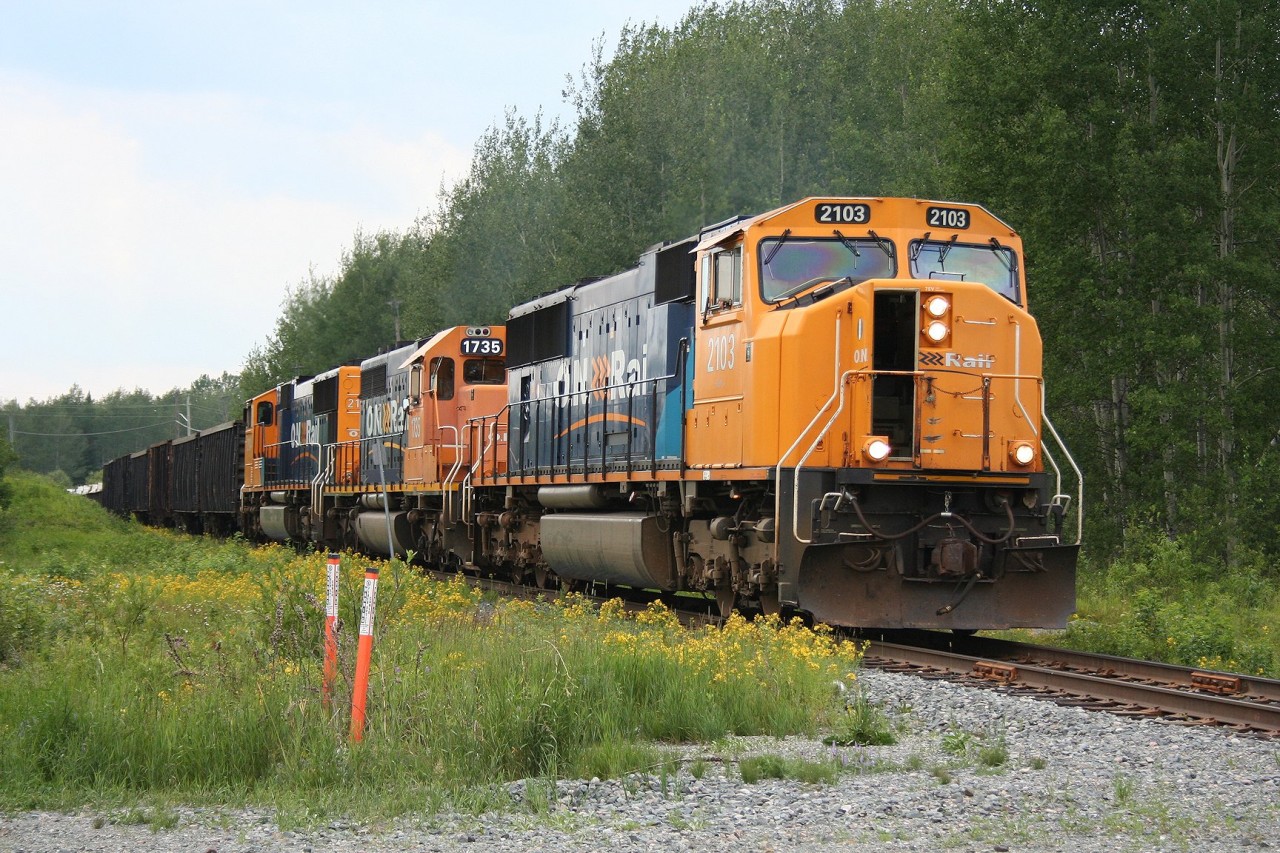 Ontario Northland SD75i 2103 along with SD40-2 1735 and SD75i 2104 crawl through a slow order at Kirkland Lake, Ontario with a rather sizeable train 211 consisting of mostly copper concentrates and empty acid tankcars bound for the smelter at Rouyn-Noranda, Quebec.
The trailing unit, ONT 2104, was lifted off of the same day's train no. 308 at the siding at Jardin. 308's left behind southbound traffic would be lifted later that evening by when this train returns from Noranda as no. 512 for Englehart.