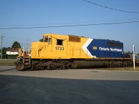 Ontario Northland SD40-2 1733 switches a string of empty flatcars to the wye track at Englehart, where a large tie loading area has been set up.