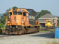 SD40-2 1735 idles in the morning sunshine on the engine track at Englehart awaiting its next assignment while in the background fellow SD40-2 1733 switches cars in Englehart yard.