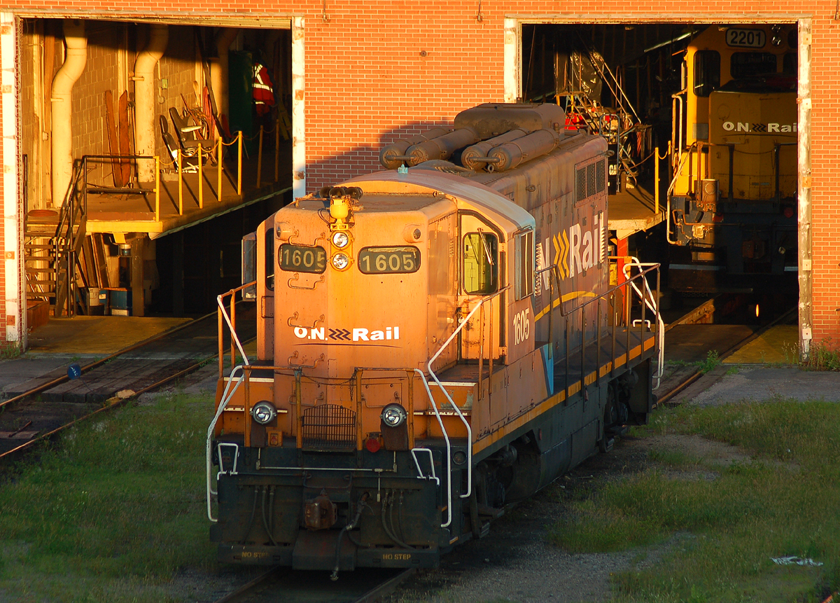 ONT GP9 #1605 basking in the late evening sun, as ONT 2201 sits just inside the shop
