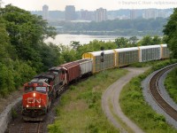 CN M331 is heading up the Cowpath to the delight of a few railfans on the Bridge at the annual Bayview Meet. In the background is Hamilton, Ontario downtown.