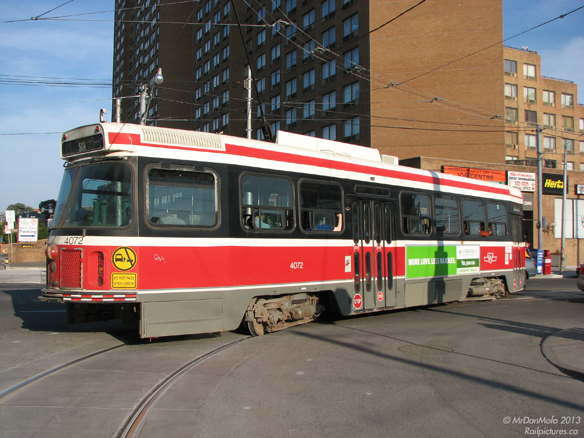 Now that's a tight curve! TTC streetcar 4072 leaves Dundas West Station for downtown on another 504 King run, negotiating the curve out of the station onto Dundas Street West from Edna Ave. Note the catcher wire for the trolley pole strained to the extreme rear right of the car, and the amount of rear end swing.