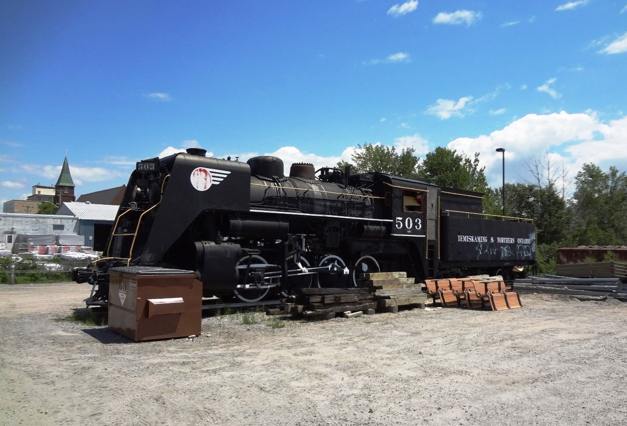 T&NO #503 now sits on a track panel surrounded by dumpsters, track ties, bridge timber, and yet to be installed park benches. Since I last photographed this locomotive in April of 2002 it has been cleaned and repainted to help protect it from the elements. It still sits in an unprotected area at the end of the North Bay, ON station parking lots where vandals have easy access to it with their spray cans. Remnants of ONR's European 'Tee-Train' sit on the ground in a fenced-in compound just a few yards away.