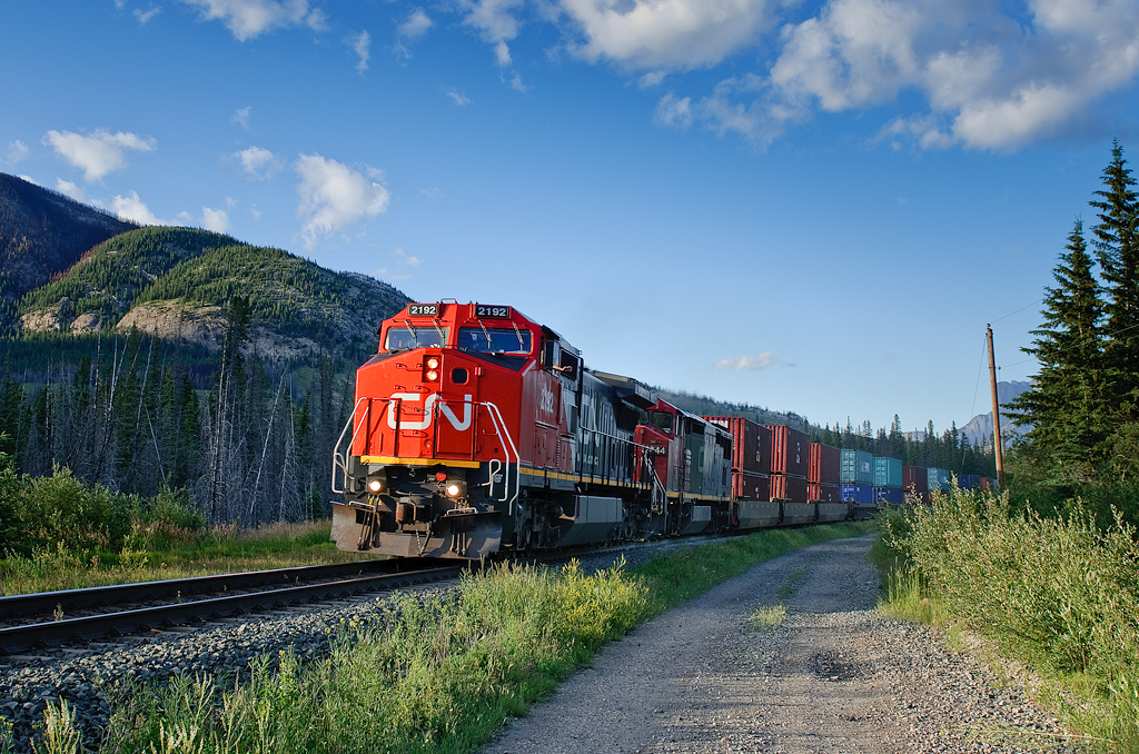 A pair of Dash 8s catch the last rays of sunshine, speeding west at 55mph or better with 178 platforms, 11594' of Chicago-Kamloops train.